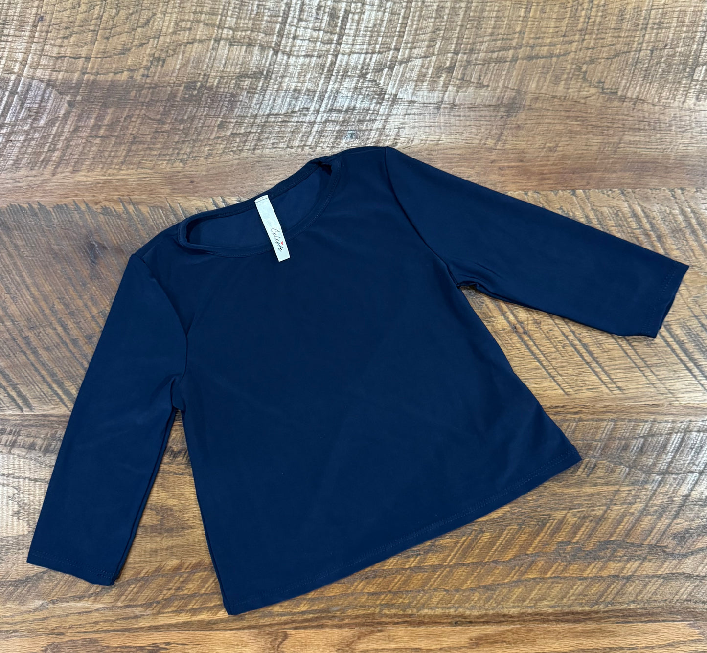 Girl's black long sleeve layering top by Celeste Clothing, featuring soft fabric and a comfortable fit for versatile layering.