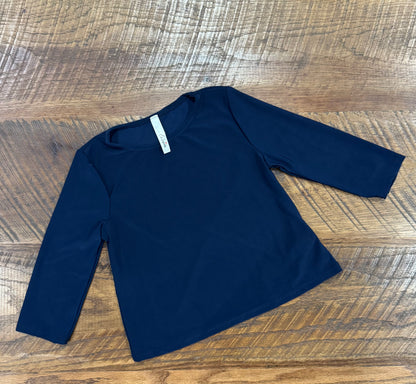 Girl's black long sleeve layering top by Celeste Clothing, featuring soft fabric and a comfortable fit for versatile layering.