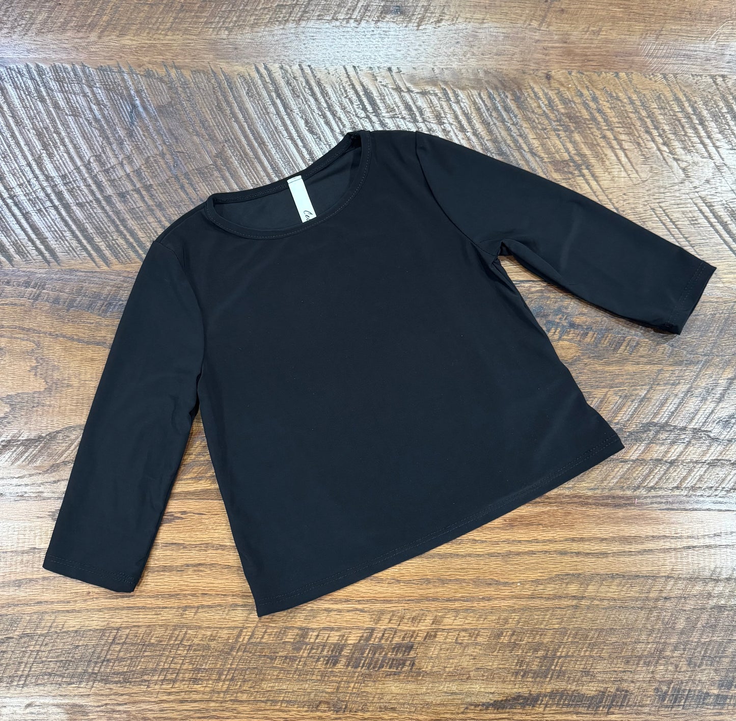 Girl's black long sleeve layering top by Celeste Clothing, soft fabric with a comfortable fit for stylish layering.