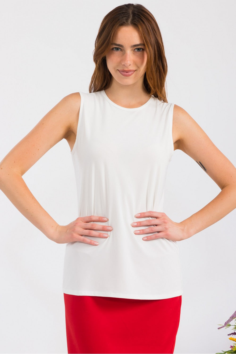 Celeste Clothing white sleeveless layering top, wrinkle-free and modest, shown on a small-sized model.