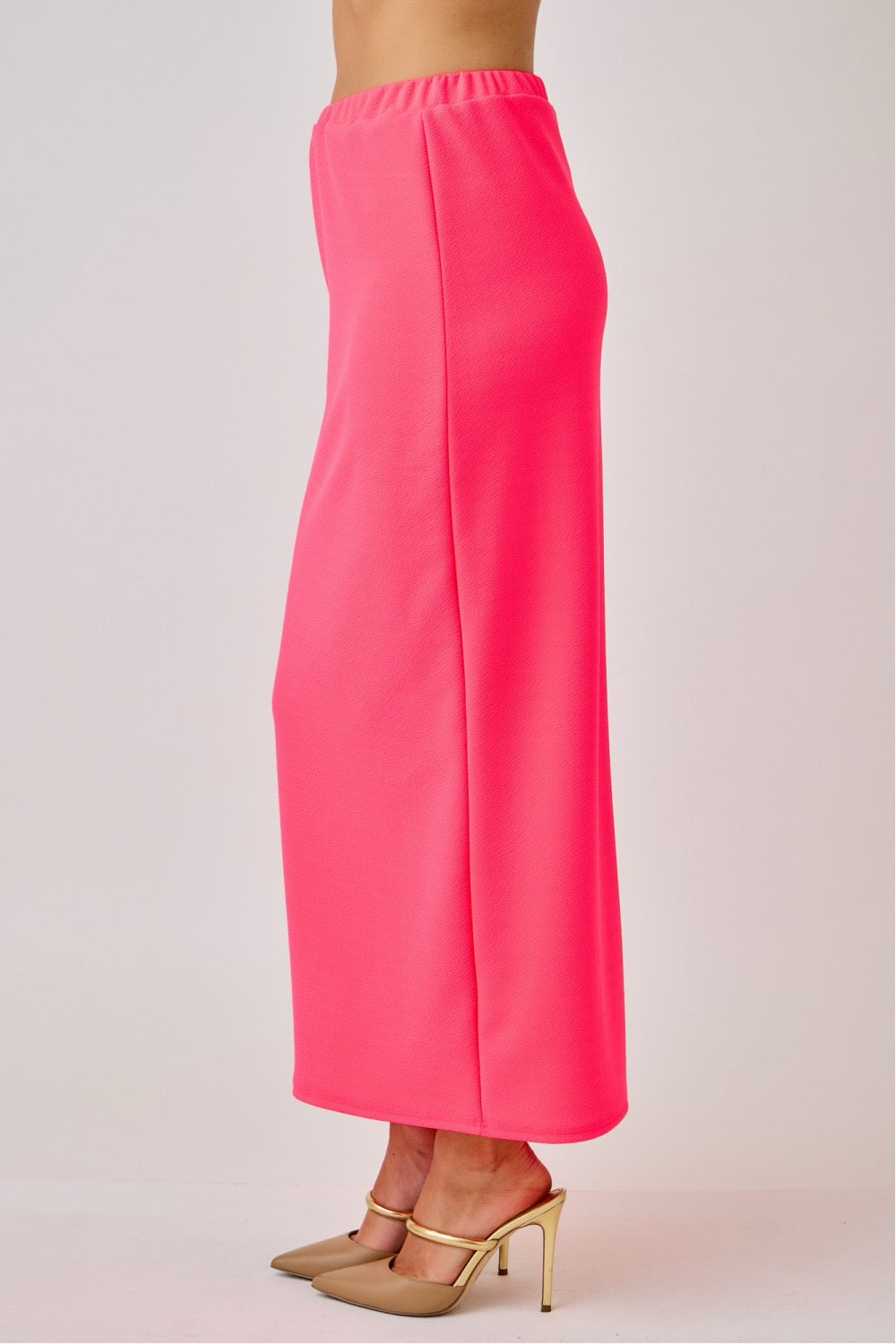 Celeste Clothing ladies maxi length pencil skirt in vibrant neon fuchsia, fitted style with smooth fabric and high waist.