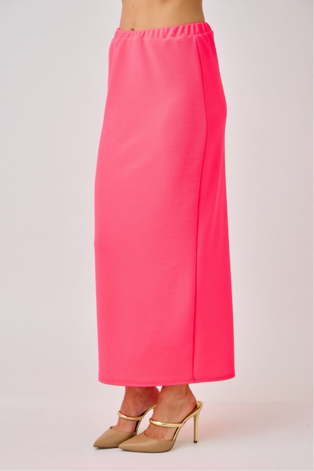 Ladies maxi length pencil skirt in vibrant neon fuchsia from Celeste Clothing, showcasing a sleek, fitted silhouette.