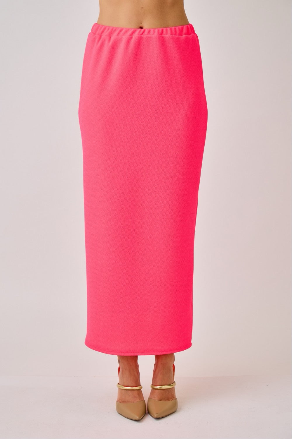 Celeste Clothing ladies maxi length pencil skirt in vibrant neon fuchsia, fitted style with smooth fabric and high waist.