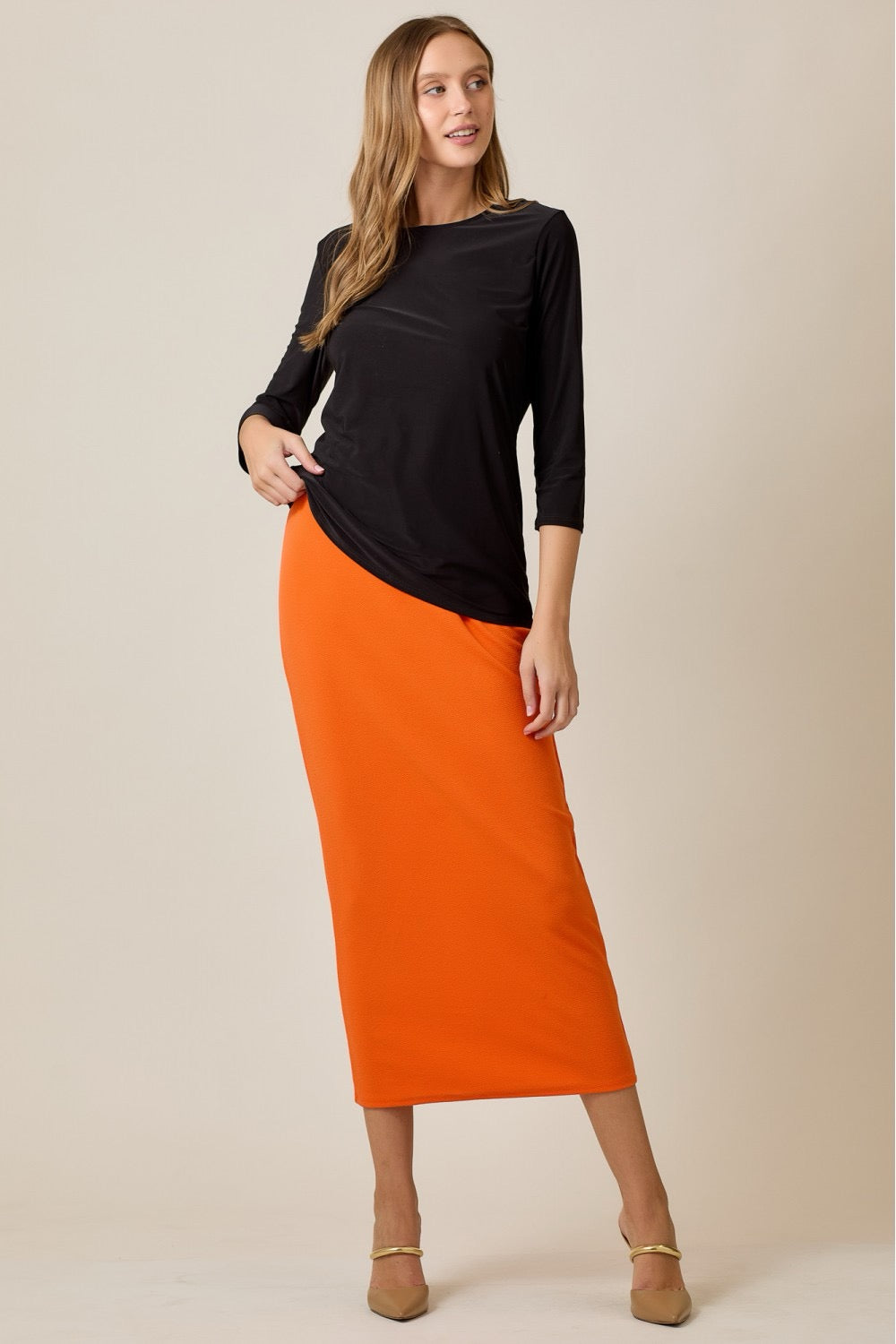 Orange ladies maxi-length pencil skirt by Celeste Clothing, featuring a fitted silhouette and elegant design.