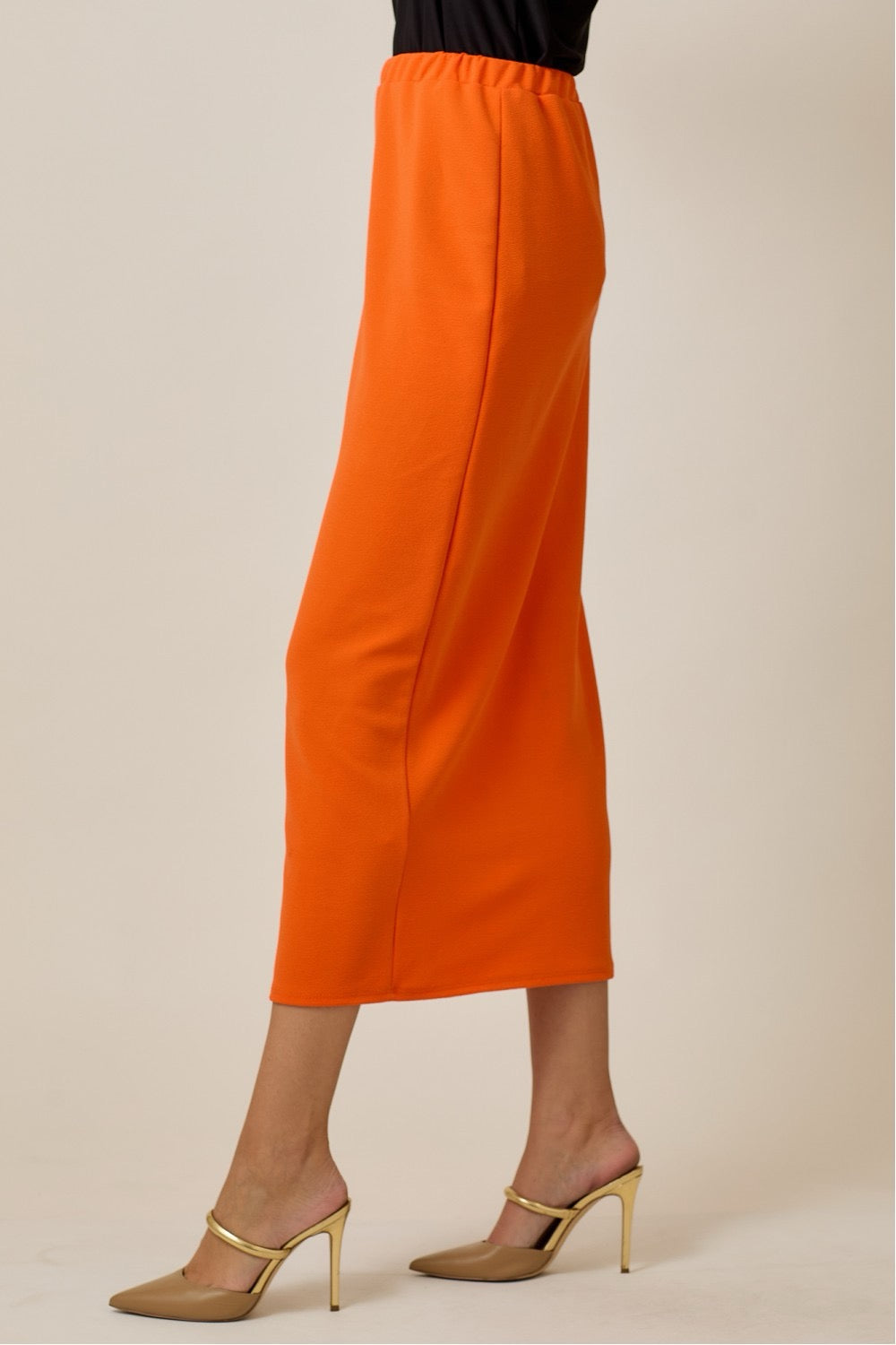 Orange ladies maxi length pencil skirt by Celeste Clothing, featuring a fitted silhouette and elegant design.