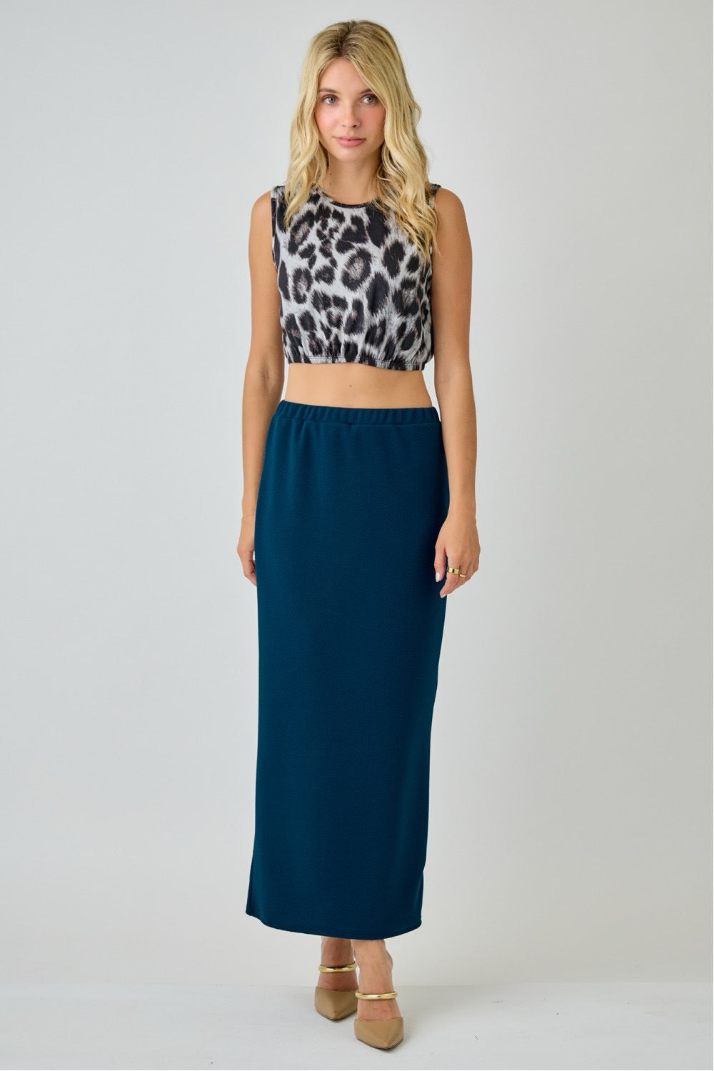 Teal ladies maxi length pencil skirt from Celeste Clothing displayed on a model, showcasing a fitted silhouette and smooth fabric.
