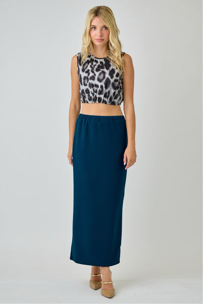 Teal ladies maxi length pencil skirt from Celeste Clothing displayed on a model, showcasing a fitted silhouette and smooth fabric.