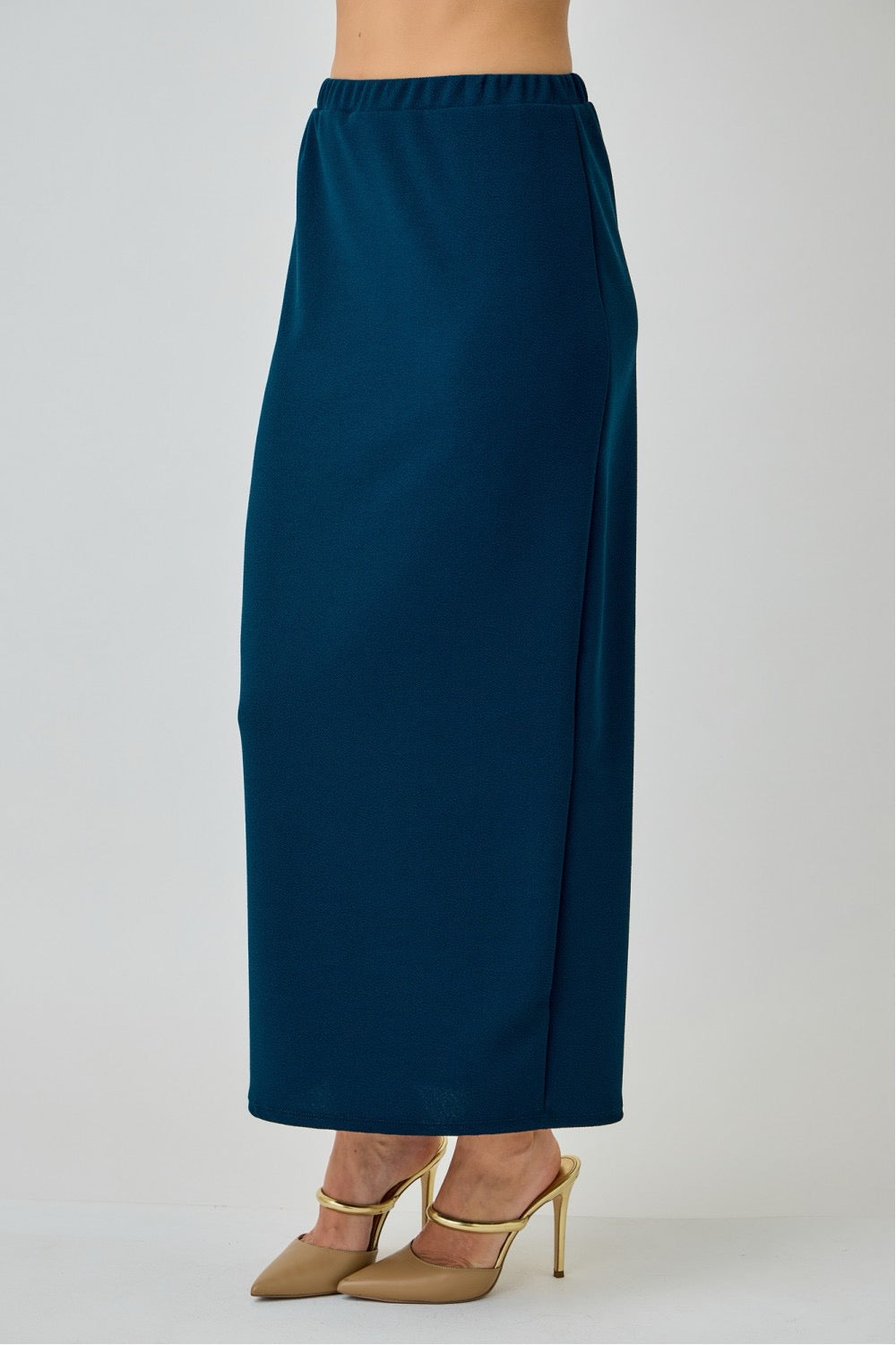 Teal ladies maxi length pencil skirt from Celeste Clothing displayed on a hanger, showing its fitted style and flowy fabric.