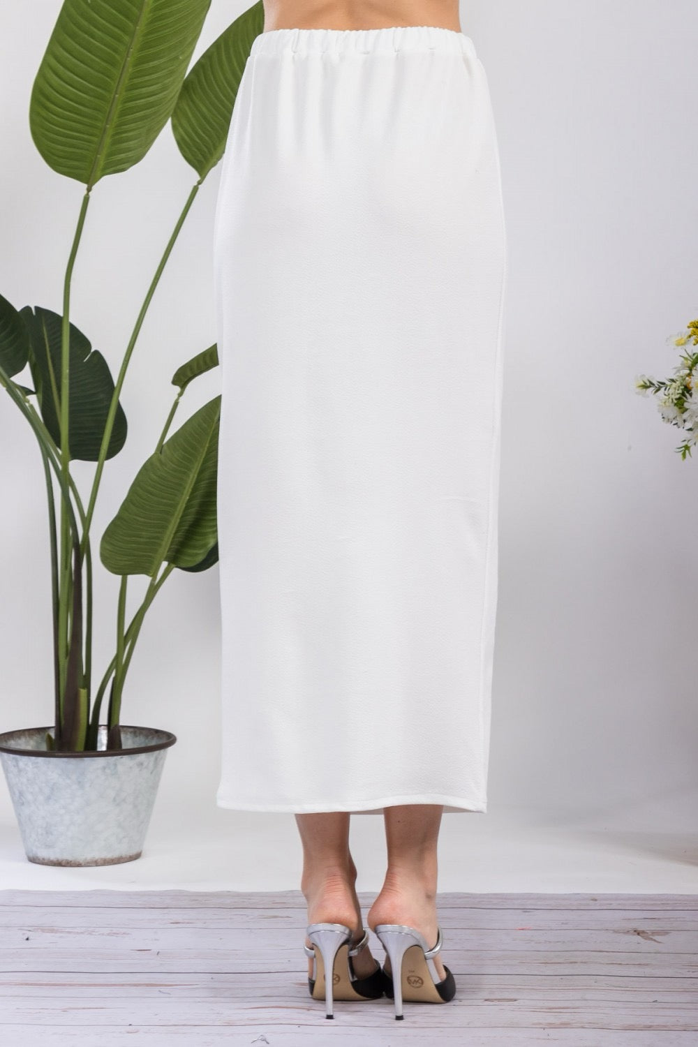 White ladies maxi length pencil skirt by Celeste Clothing, showcasing its sleek, fitted design and high-waisted style.