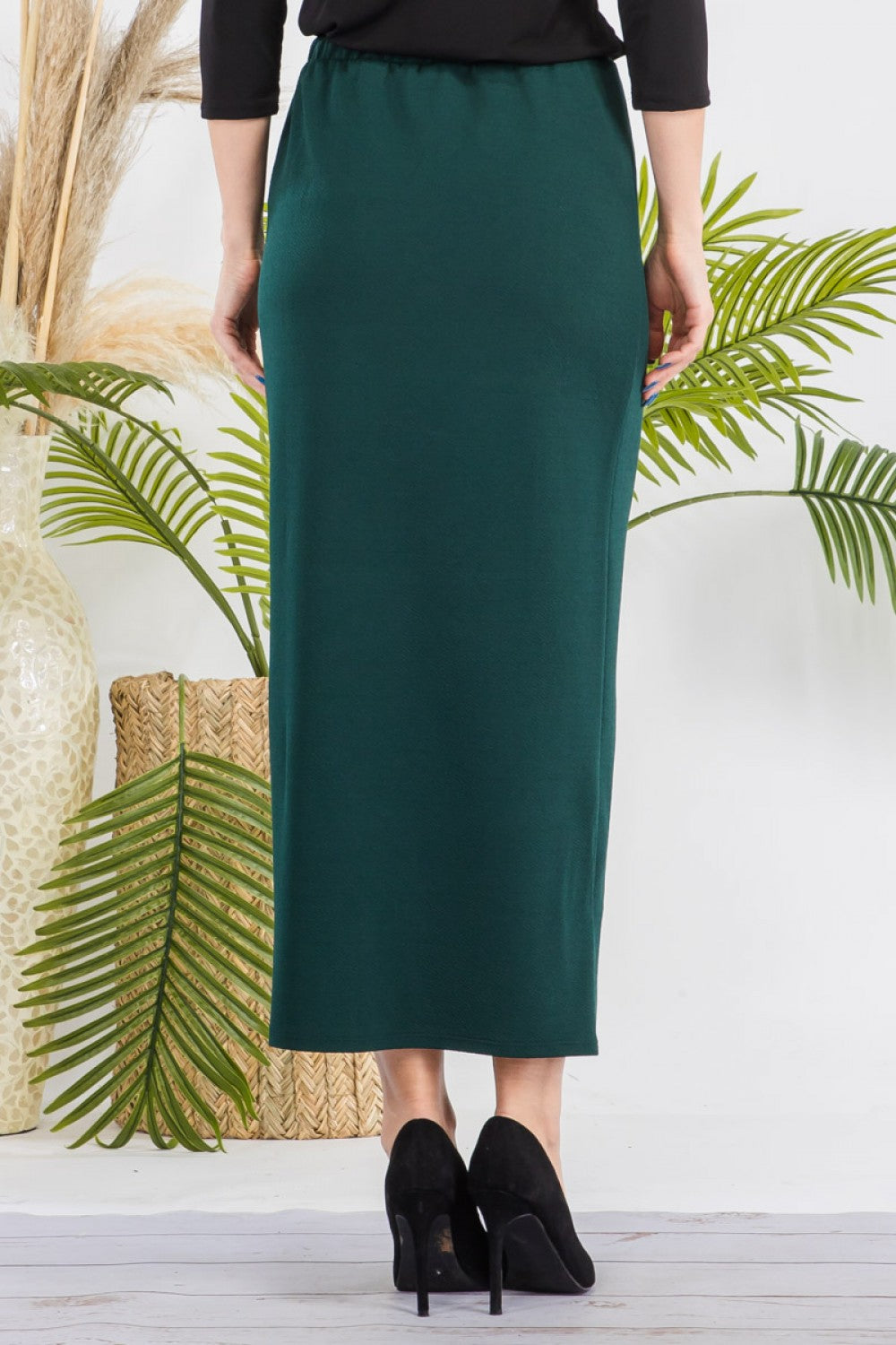 Pink ladies maxi-length pencil skirt by Celeste Clothing, shown on a small-sized model, featuring a sleek, fitted design.