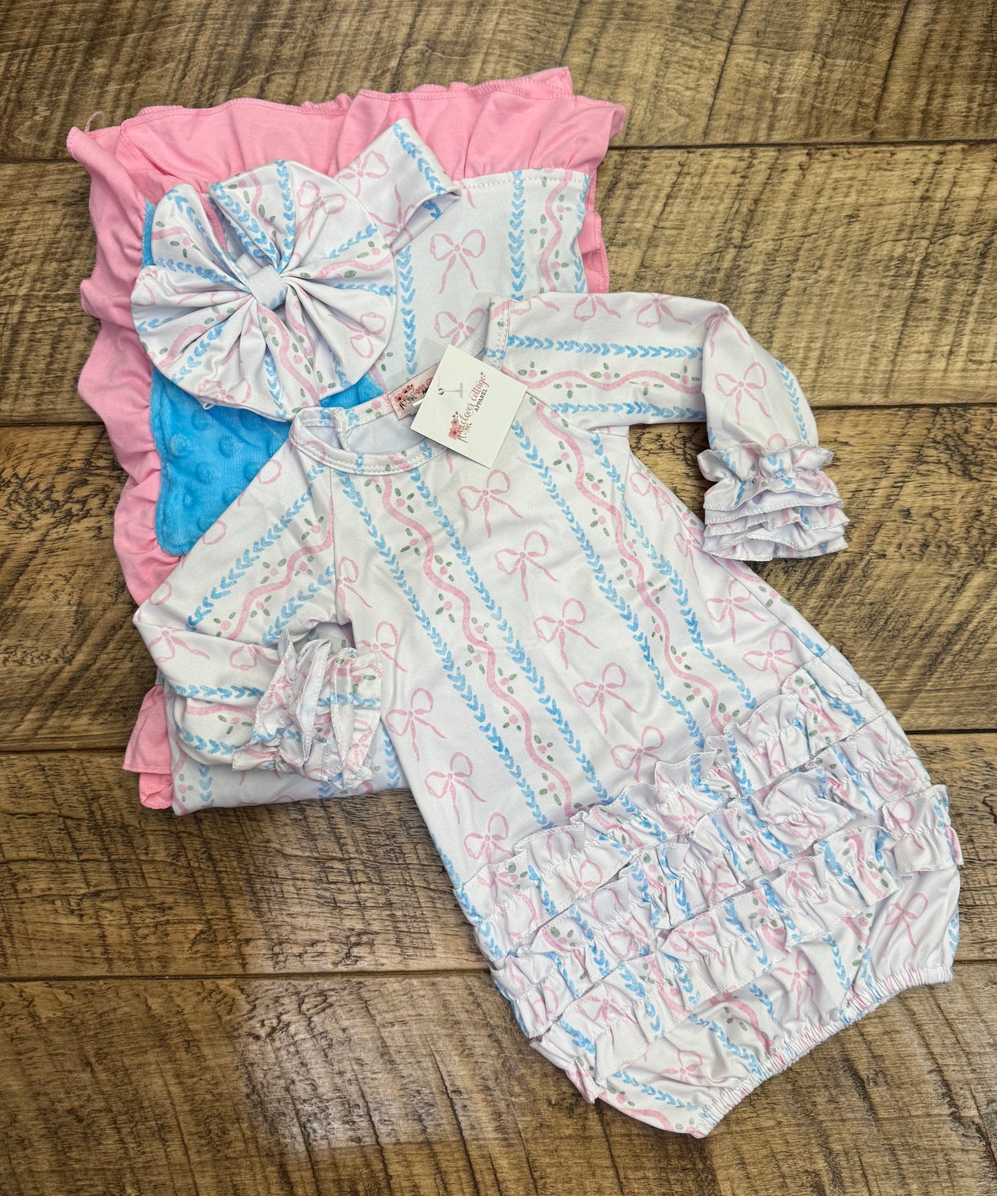 Newborn gift set by Clover Cottage with pink gown, matching headwear, and soft blanket for baby girls.