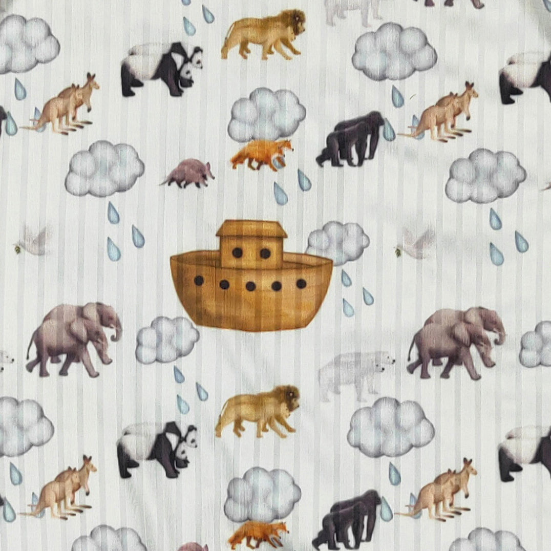 Blue Noah's Ark boy romper by Clover Cottage for 0-6 months, featuring playful animal and boat print on soft fabric.