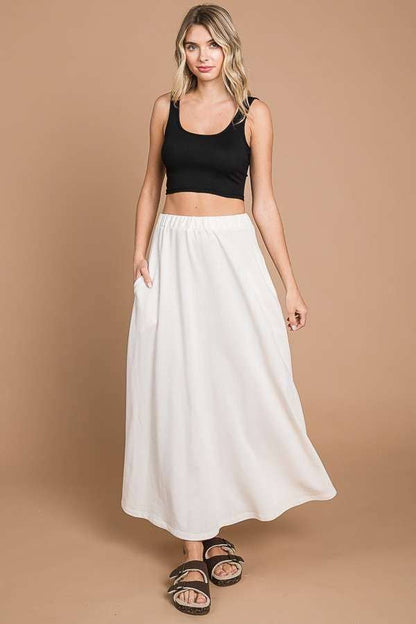 Black Culture Code maxi skirt with a full solid design and practical pockets, perfect for casual or dressy occasions.