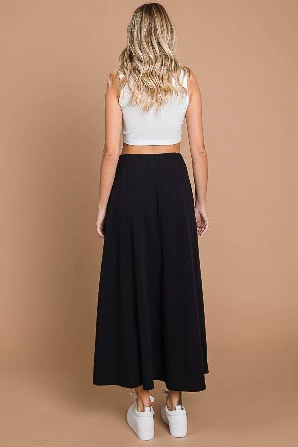 Black Culture Code maxi skirt with full solid design and convenient pockets, perfect for casual or stylish outfits.