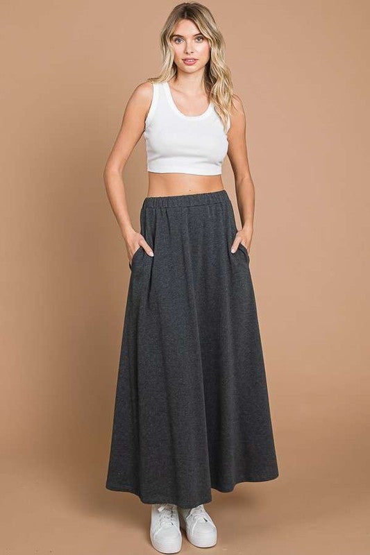 Culture Code black maxi skirt with solid fabric and convenient pockets, full-length design perfect for casual or dressy wear.