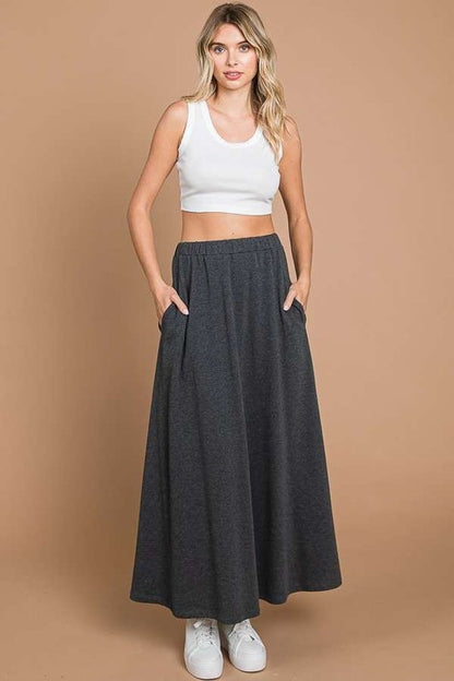 Culture Code black maxi skirt with solid fabric and convenient pockets, full-length design perfect for casual or dressy wear.