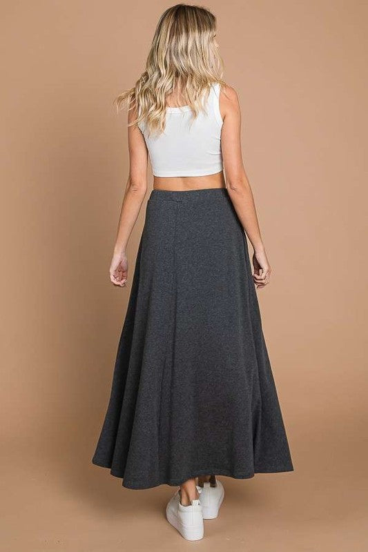 Black Culture Code maxi skirt with full solid fabric and convenient pockets, featuring a comfortable, flowing design.