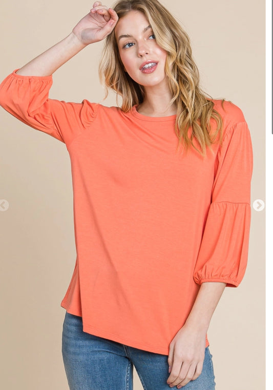 CultureCodeUSA coral 3/4 sleeve bubble top with round neckline, solid color and casual style, shown on a model.