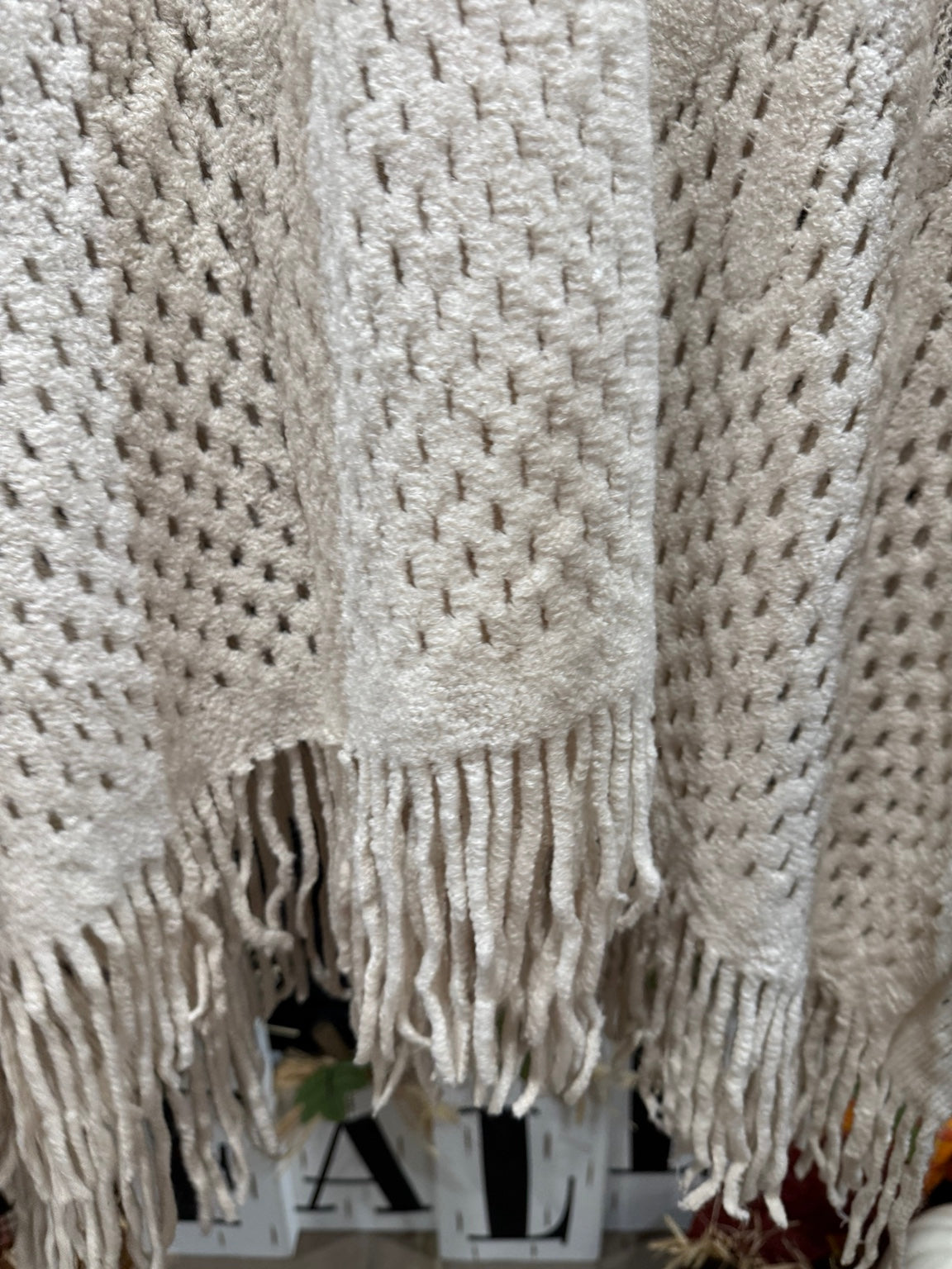 Ivory poncho fringe detail