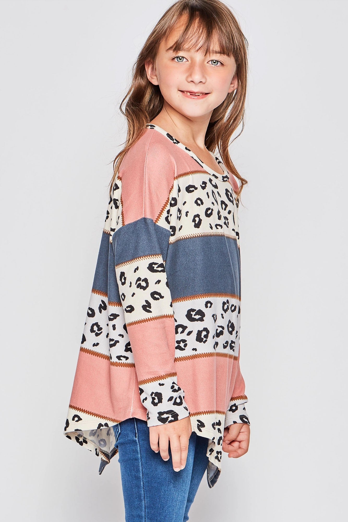 Girls long sleeve leopard print asymmetrical top by GtoG, stylish girl’s shirt with animal print and unique hem detail.