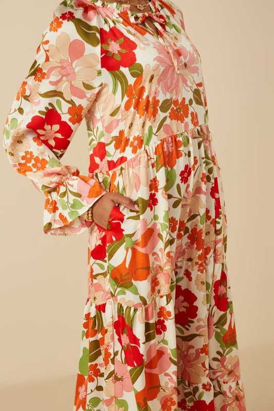 Women's satin floral tie neck tiered maxi dress by Hayden Los Angeles, shown with flowing fabric and floral pattern.