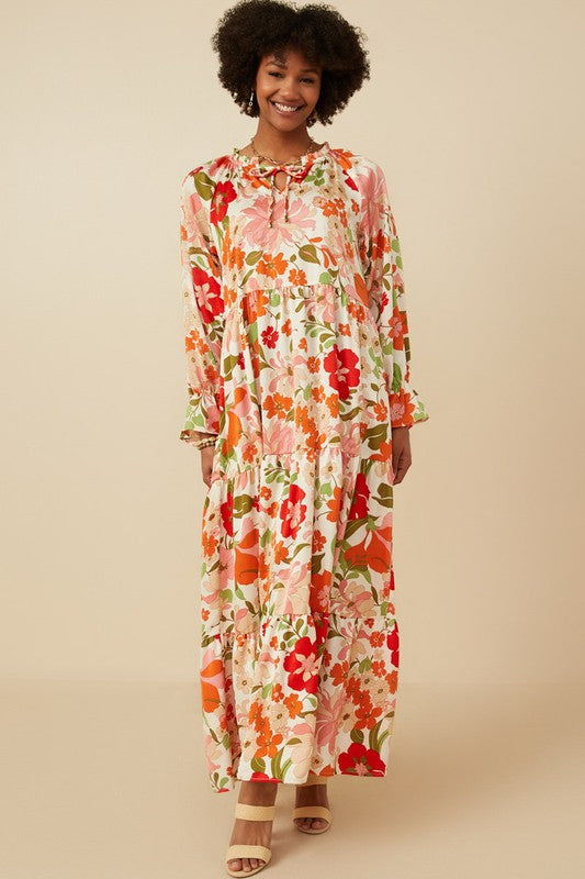Women's satin floral tiered maxi dress by Hayden Los Angeles with tie neck, featuring a flowy, elegant design and vibrant floral pattern.