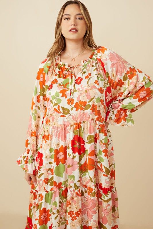 Women's satin floral tie neck tiered maxi dress by Hayden Los Angeles, flowing fabric with a floral pattern and elegant design.