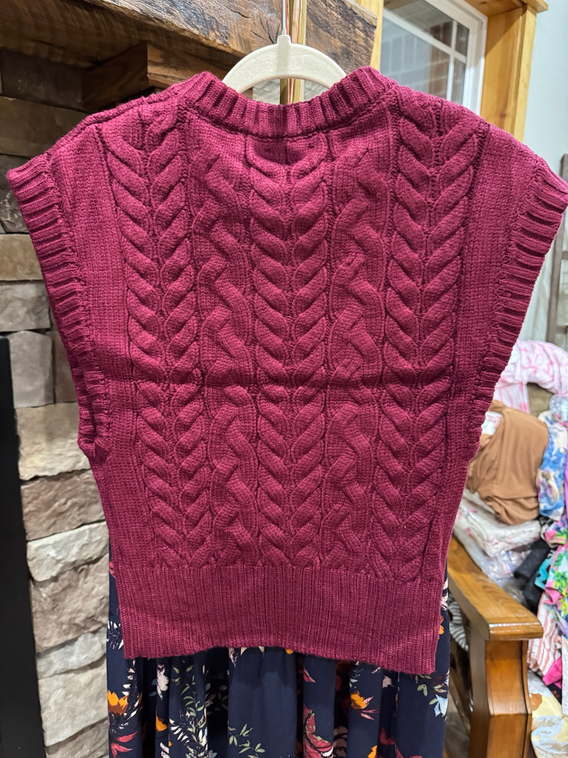 Back of Heyson burgundy cable-knit sweater vest showing braided cable panels and ribbed hem