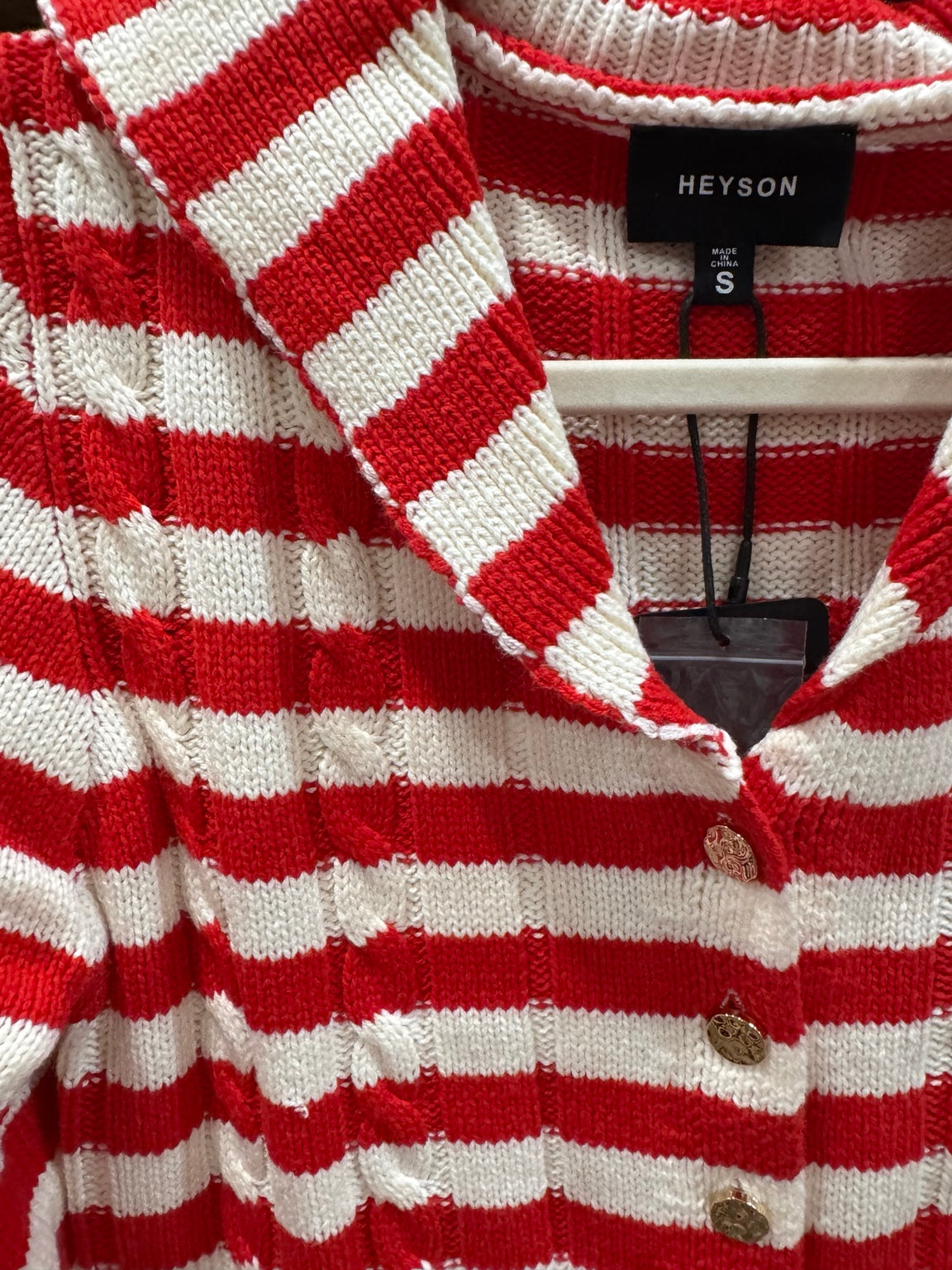 Close view of HEYSON red and cream striped cardigan collar