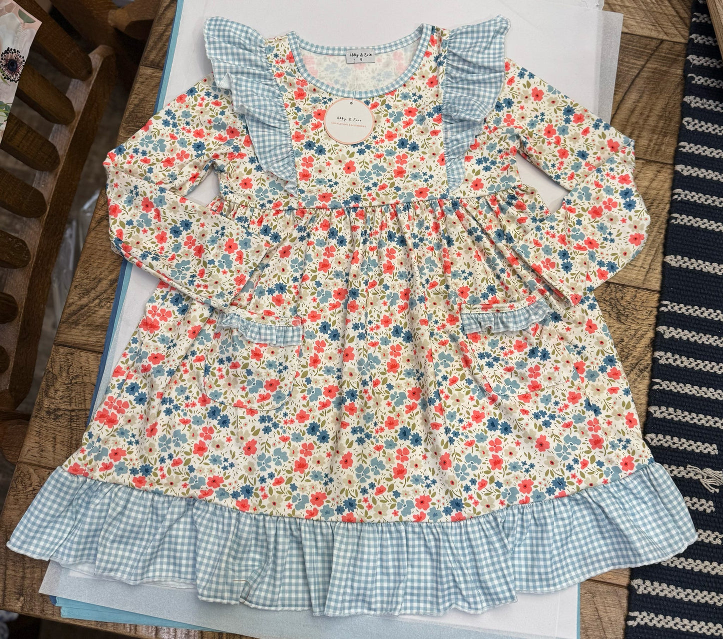 Assorted girls' summer dresses by HoneyDew featuring navy trim and blue floral patterns for 12-month-olds.