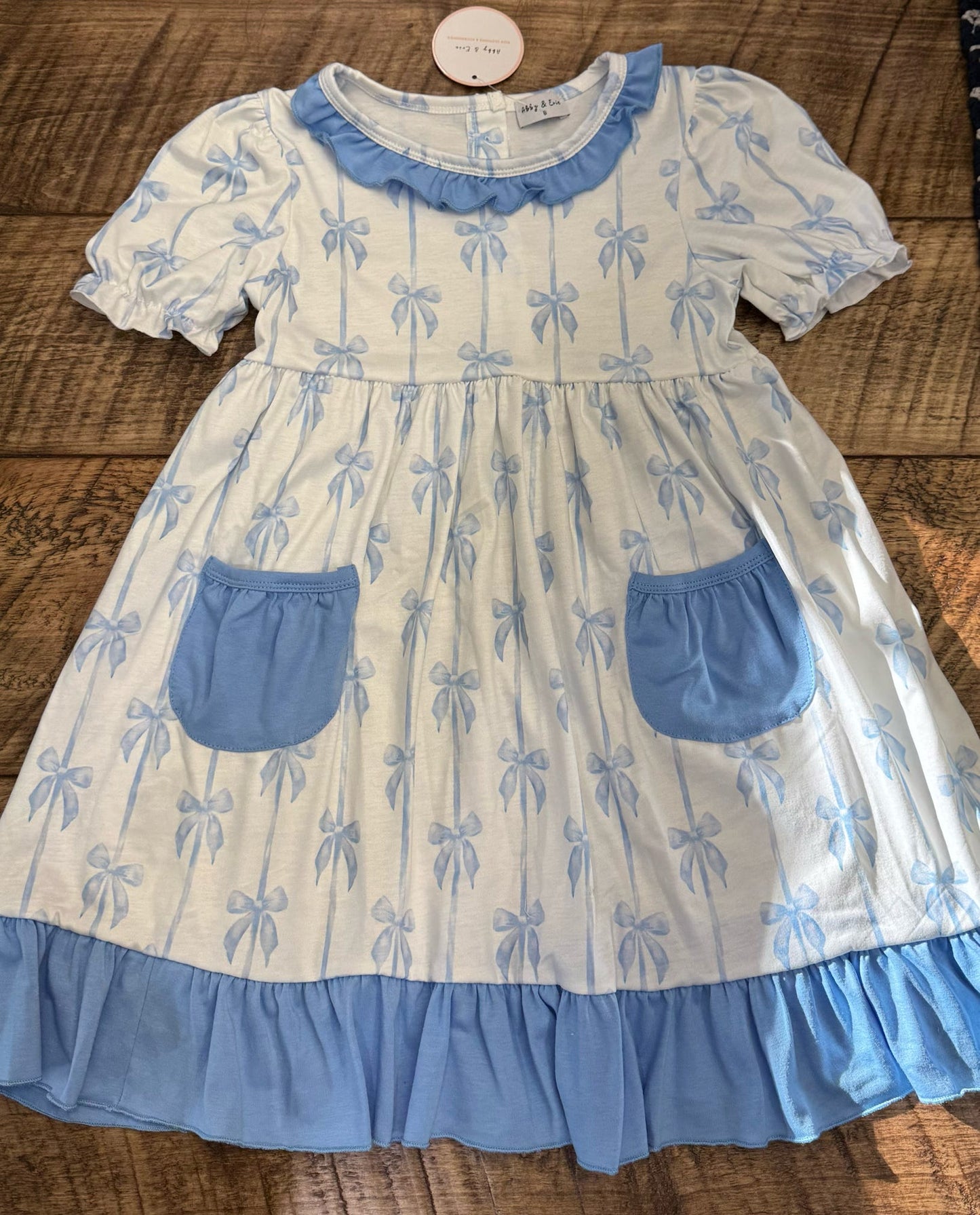 Assorted girls' summer dresses by HoneyDew featuring navy trim and blue floral patterns, suitable for 12-month-old girls.