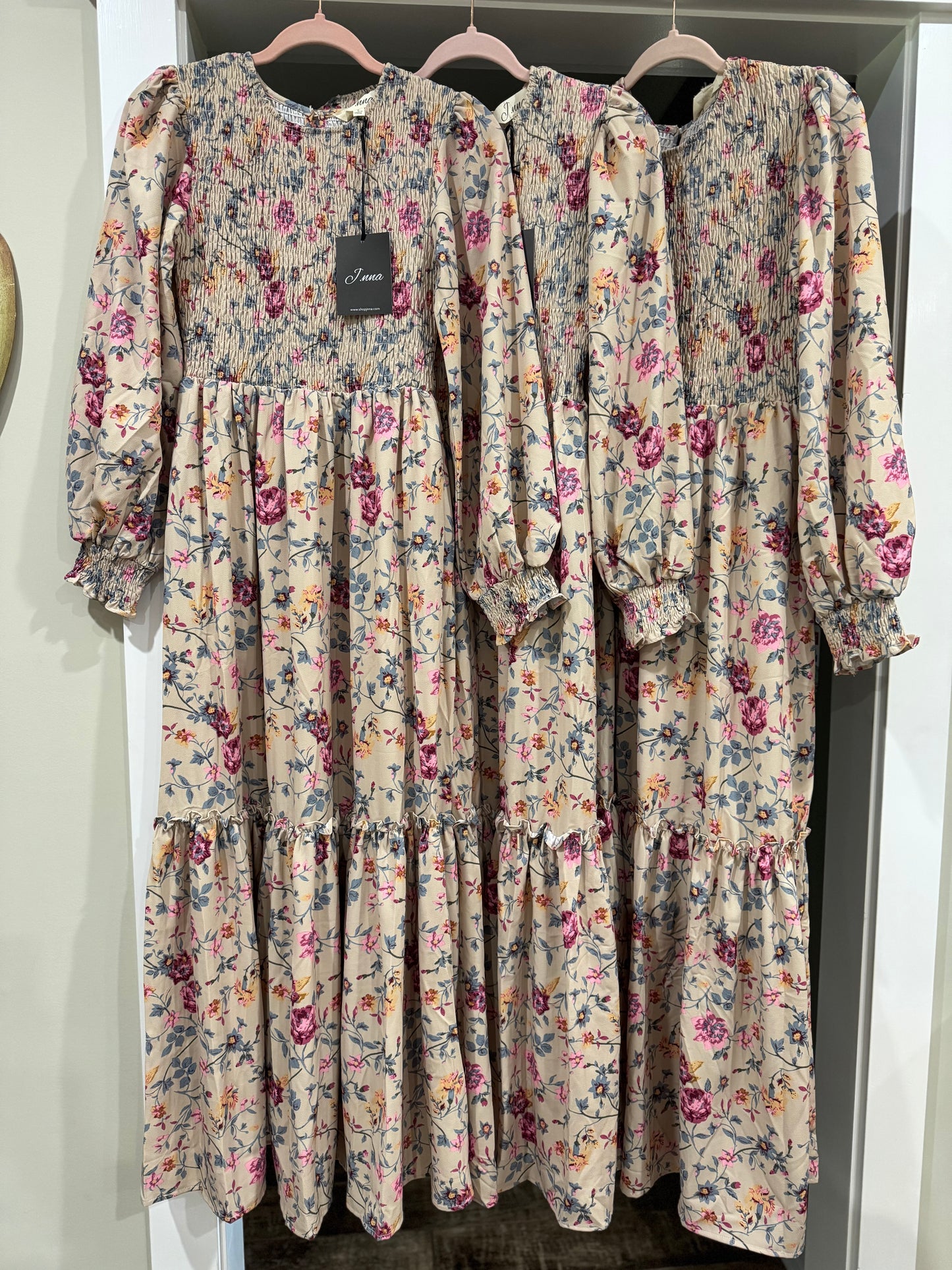Floral print smocked tiered maxi dress by J.NNA with flowing fabric and vibrant floral pattern, perfect for summer wear.