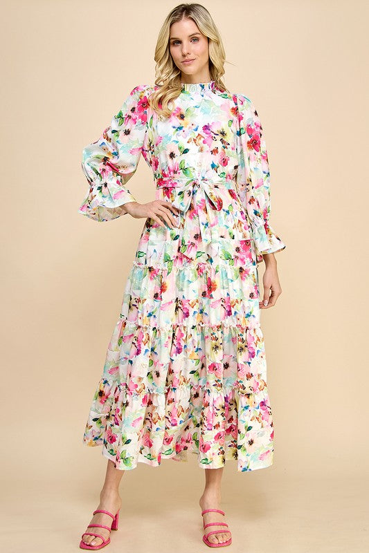 Long sleeve floral print maxi dress with ruffle accents by JJ's Fairyland, featuring a flowing silhouette and vibrant floral pattern.