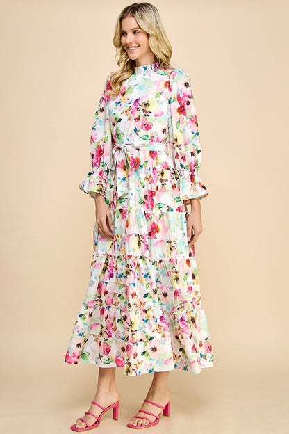 Long sleeve floral print maxi dress by JJ's Fairyland featuring ruffle accents and a flowing design for elegant style.
