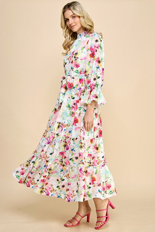 Long sleeve floral print maxi dress with ruffle accents by JJ's Fairyland, featuring a flowing silhouette and vibrant floral pattern.