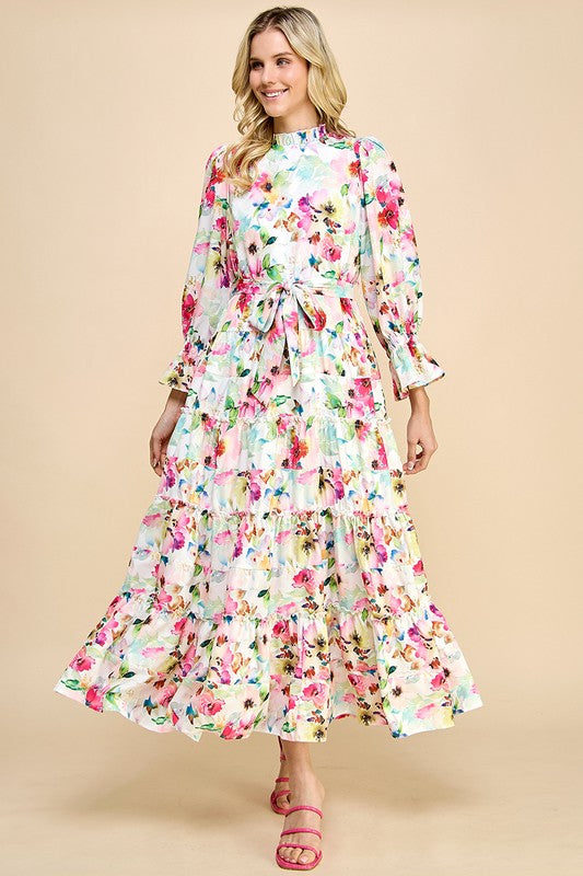 Long sleeve floral print maxi dress with ruffle accents by JJ's Fairyland, featuring a flowing silhouette and vibrant floral pattern.