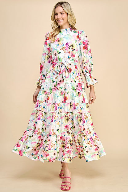 Long sleeve floral print maxi dress with ruffle accents by JJ's Fairyland, featuring a flowing silhouette and vibrant floral pattern.