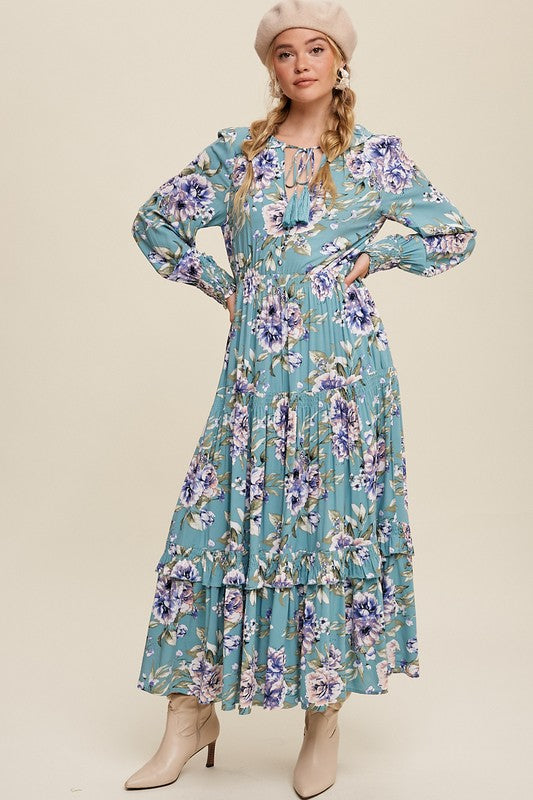 Listicle floral print maxi dress with tie-front detail, flowing fabric, and vibrant flower pattern on a sunny outdoor setting.