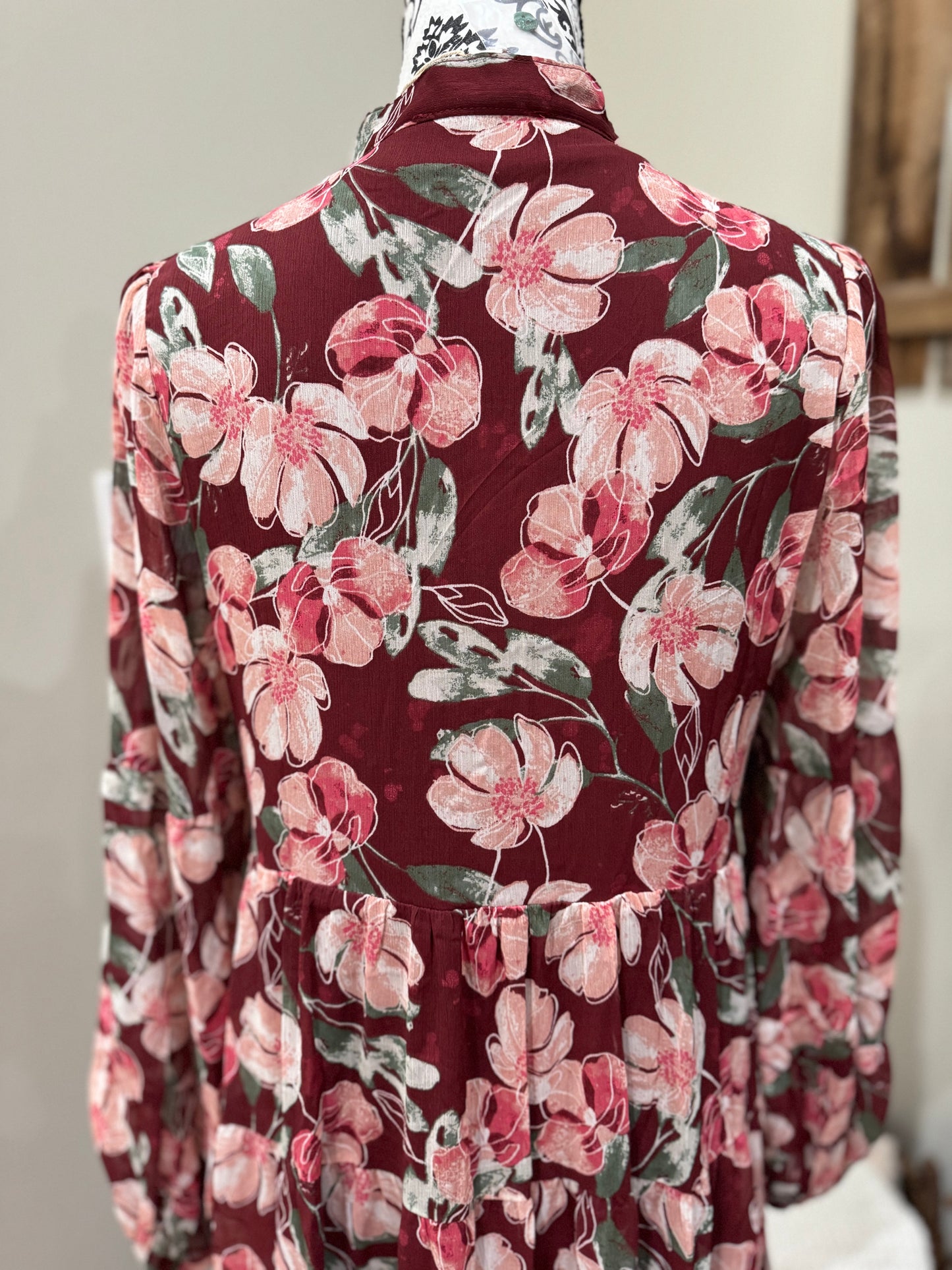 Floral flowy long sleeve button-down maxi dress by Listicle, featuring a relaxed fit and vibrant floral pattern.