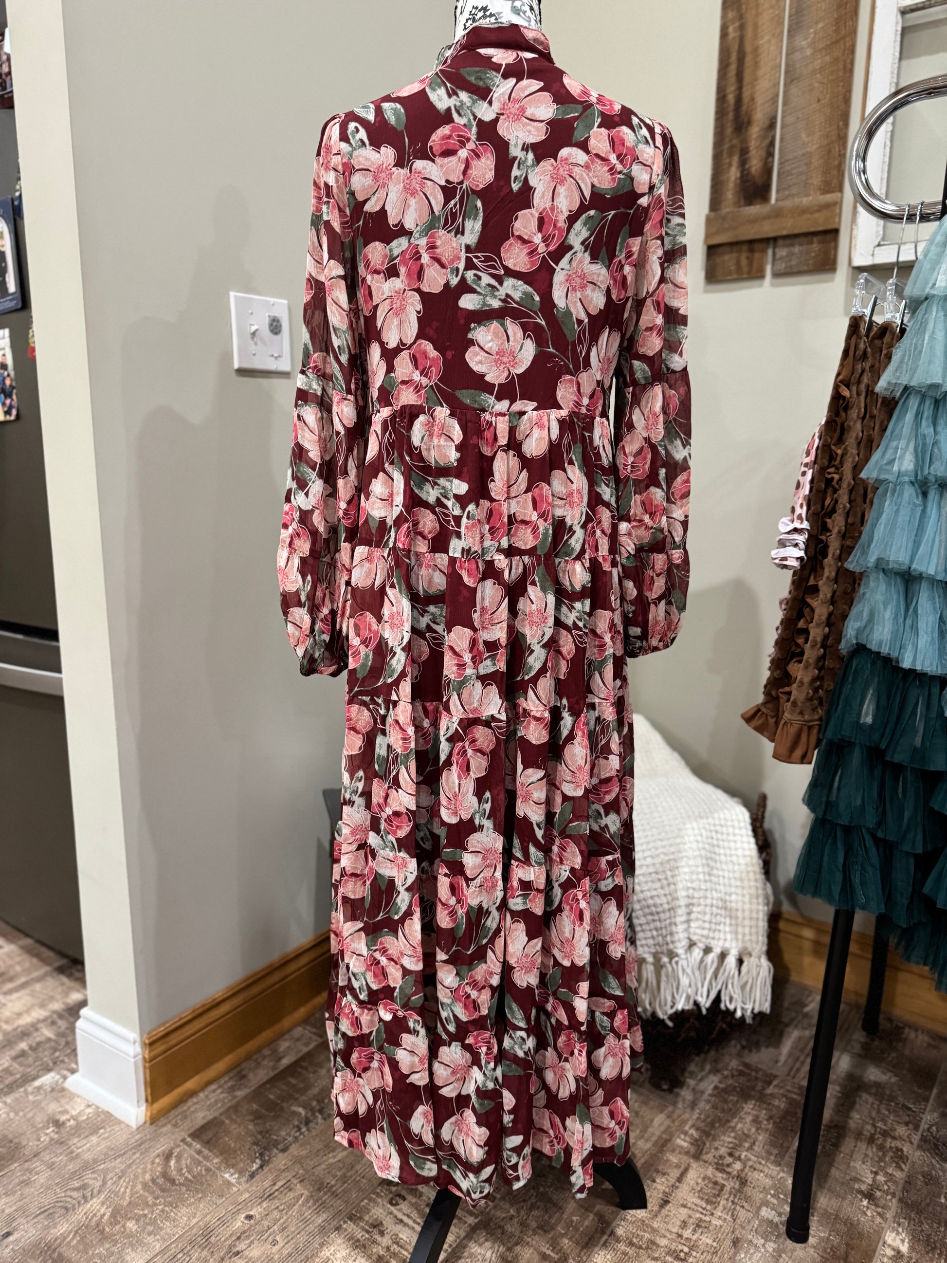 Floral flowy long sleeve button-down maxi dress by Listicle featuring a relaxed fit and vibrant floral pattern.