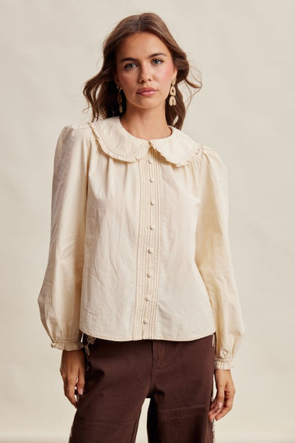 Cream long sleeve blouse with contrast stitch Peter Pan collar by Listicle, featuring a stylish and feminine design.
