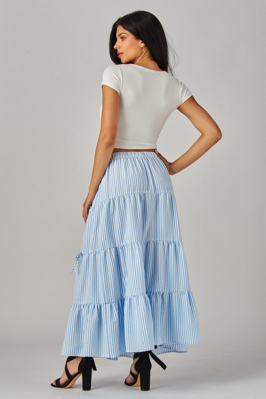 Blue Love Poem maxi skirt with stripes and bows, featuring a flowy design and elastic waistband for a stylish, comfortable fit.
