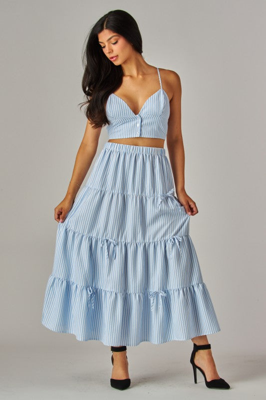 Blue Love Poem maxi skirt with stripes and bows, flowing design, shown on a model with a relaxed, elegant look.