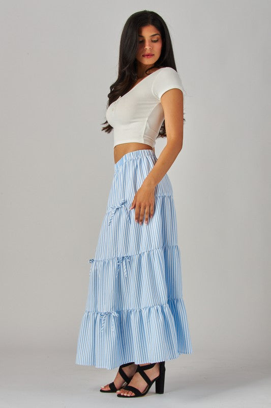 Blue Stripes and Bows Maxi Skirt by Love Poem showcasing a flowy design with a stylish waistband and playful bow details.