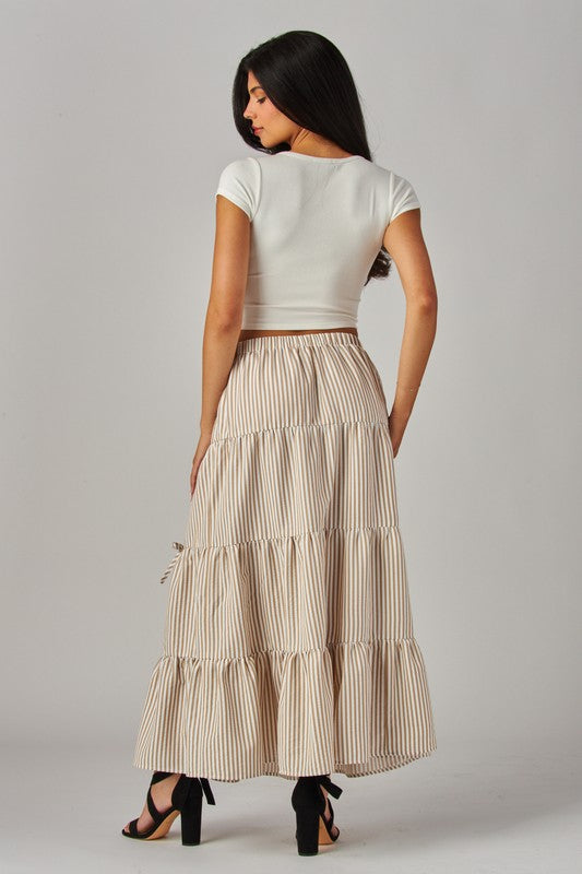 Khaki Love Poem maxi skirt with stripes and bows, featuring a flowy design and elegant waistband.