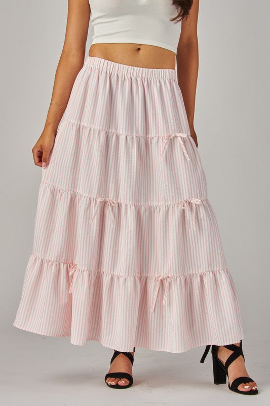 Pink Love Poem maxi skirt with stripes and bows, featuring a flowy fabric and stylish design perfect for casual or dressy wear.