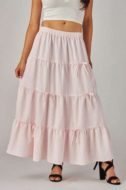 Pink Love Poem maxi skirt with stripes and bows, featuring a flowy fabric and stylish design perfect for casual or dressy wear.