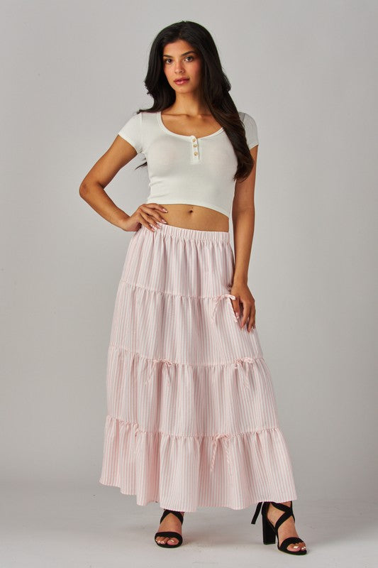 Pink Love Poem maxi skirt with stripes and bows, featuring a flowing design and elegant waistband.