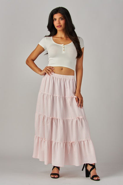 Pink Love Poem maxi skirt with stripes and bows, featuring a flowing design and elegant waistband.