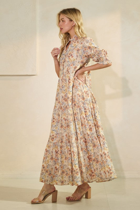 Long sleeve floral maxi dress by Lovelo featuring a vibrant floral pattern and flowing silhouette.